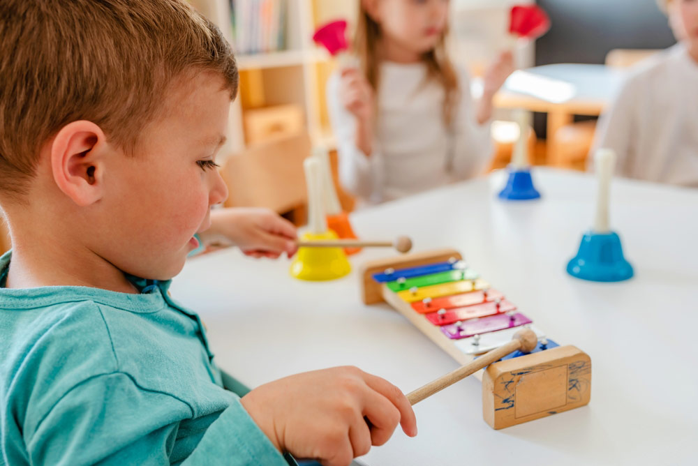 Little Boy Playing With A Musical Instrument