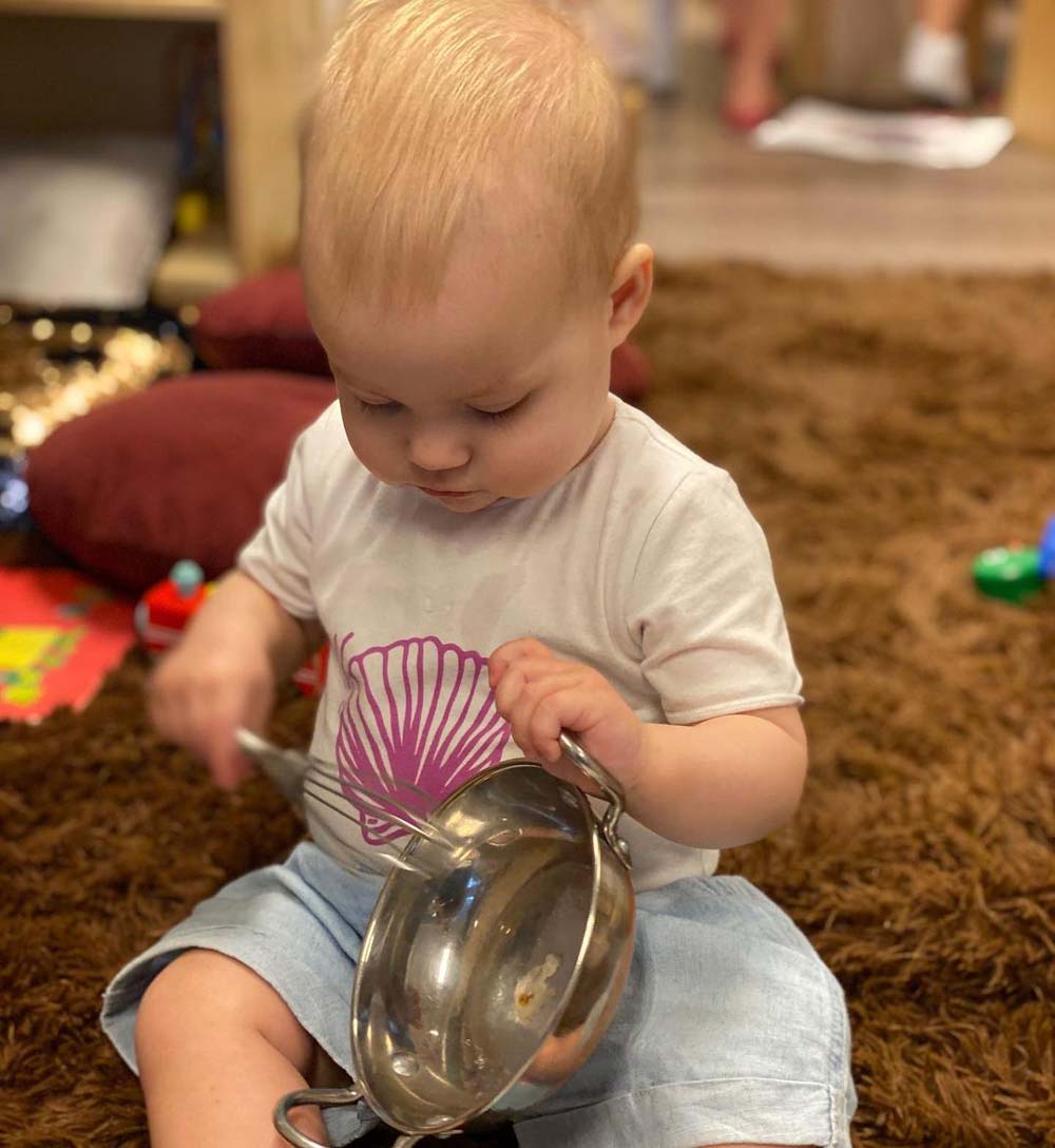 Little One Using A Household Item As Musical Instrument